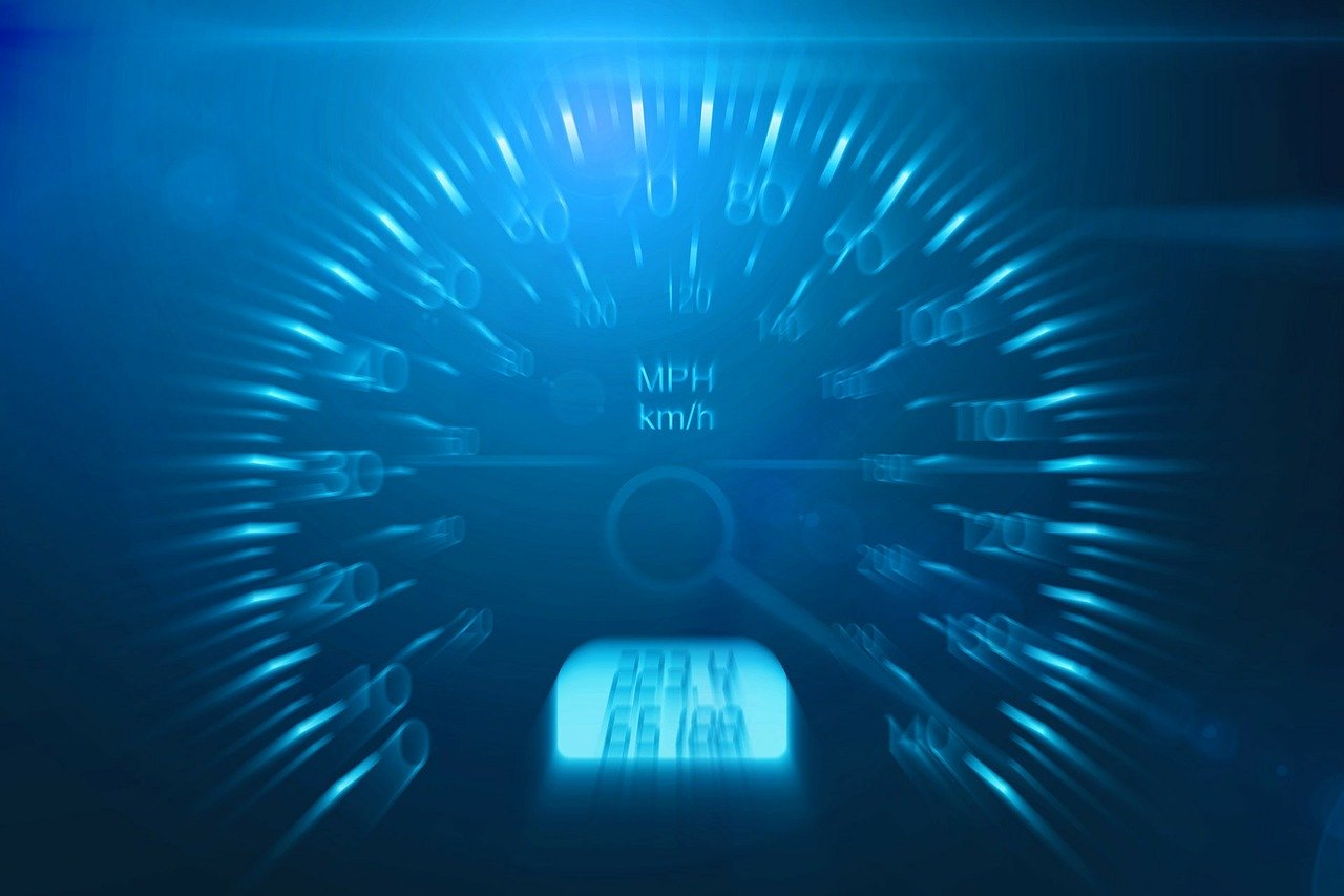 Speedometer closeup (showing blue LED) representing fast speed
